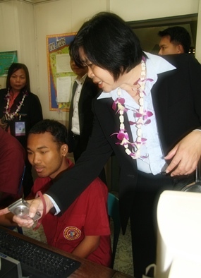 A Thai delegate meets one of the students with disabilities.